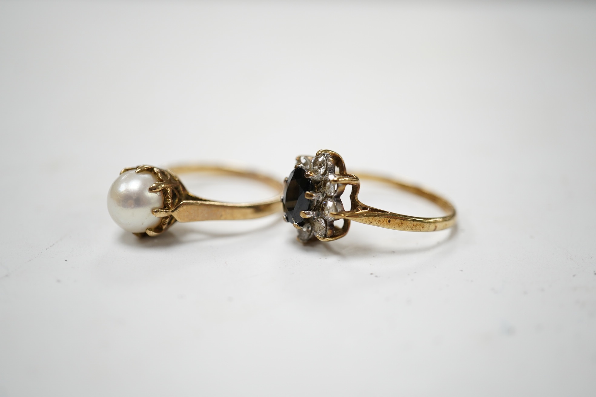 A 9ct gold, sapphire and simulated diamond cluster set ring, size M and a 9ct gold and cultured pearl set ring, gross weight 5 grams. Condition - fair